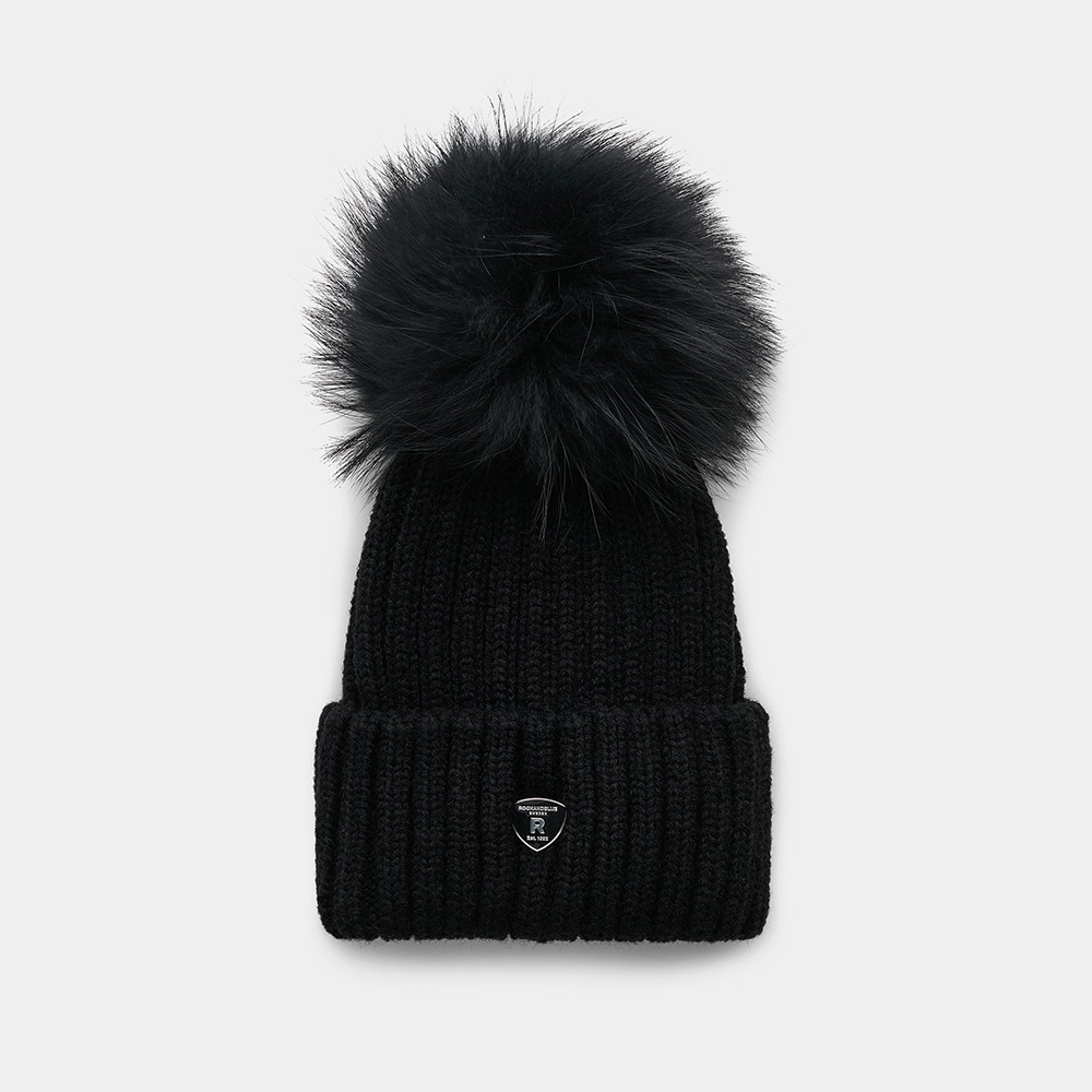 rock and blue pom pom beanie